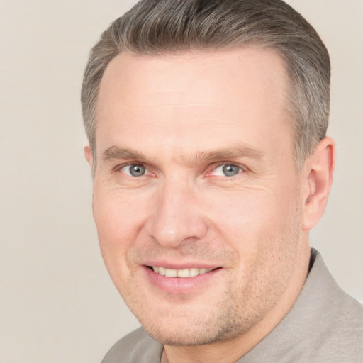 Joyful white adult male with short  brown hair and brown eyes