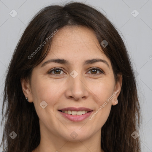 Joyful white adult female with long  brown hair and brown eyes