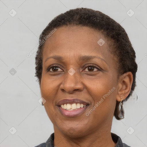 Joyful black adult female with short  brown hair and brown eyes