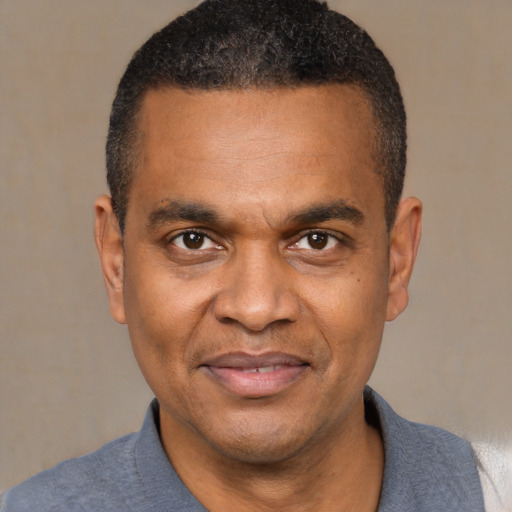 Joyful latino adult male with short  black hair and brown eyes