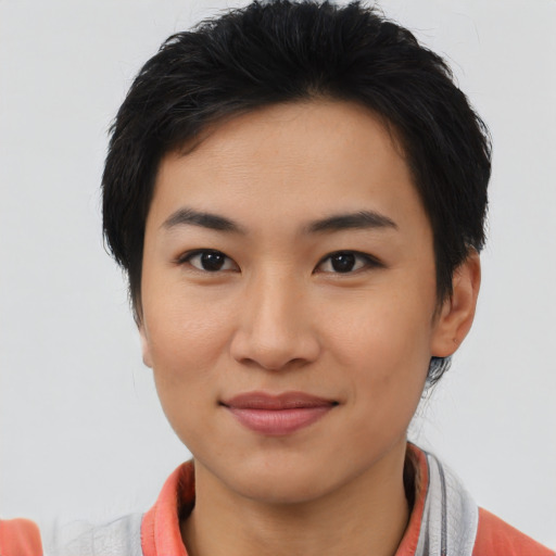 Joyful asian young-adult female with short  brown hair and brown eyes