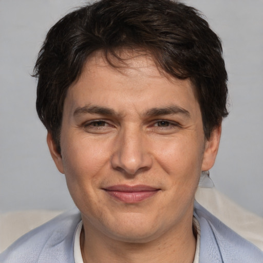 Joyful white adult male with short  brown hair and brown eyes