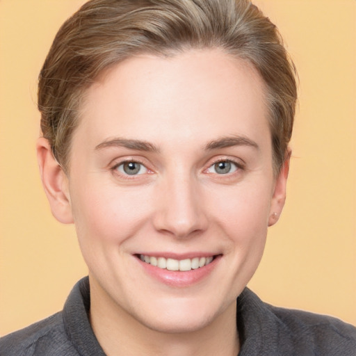 Joyful white young-adult female with short  brown hair and grey eyes