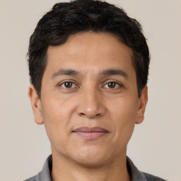 Joyful white adult male with short  black hair and brown eyes