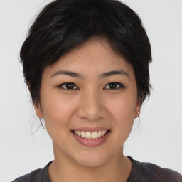 Joyful asian young-adult female with short  brown hair and brown eyes