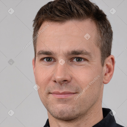 Joyful white adult male with short  brown hair and brown eyes