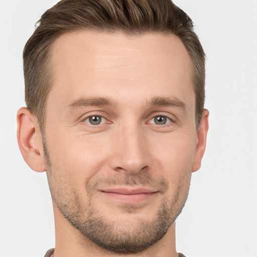 Joyful white young-adult male with short  brown hair and brown eyes