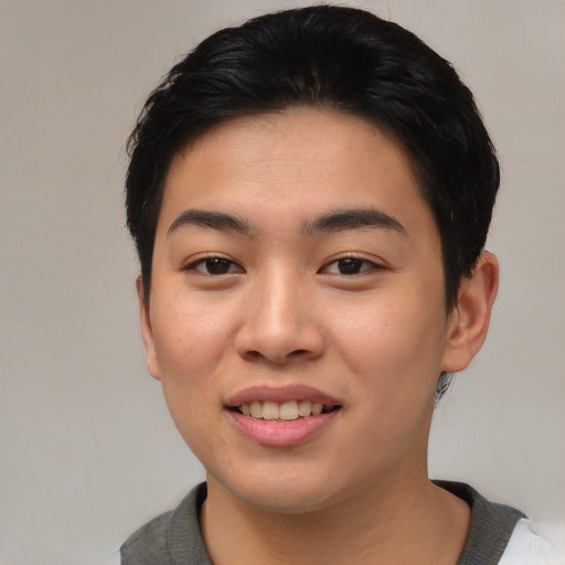 Joyful asian young-adult male with short  brown hair and brown eyes