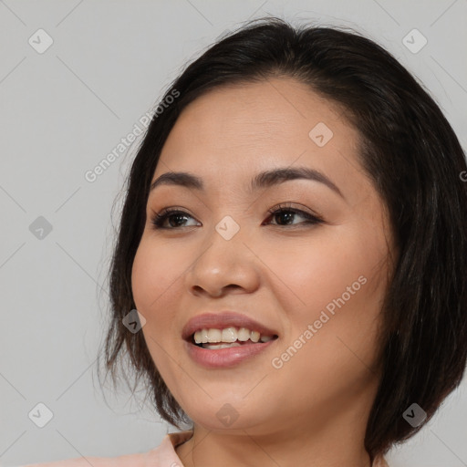 Joyful asian young-adult female with long  brown hair and brown eyes