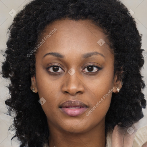 Joyful black young-adult female with long  brown hair and brown eyes