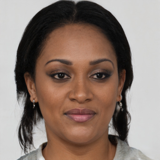 Joyful black young-adult female with medium  black hair and brown eyes