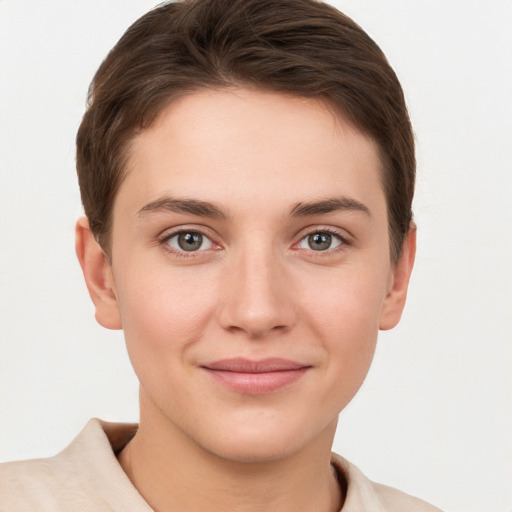 Joyful white young-adult female with short  brown hair and grey eyes