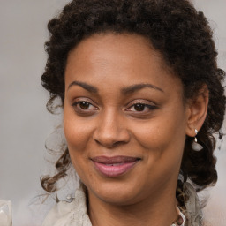 Joyful black young-adult female with medium  brown hair and brown eyes