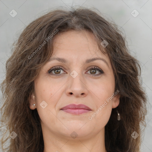 Joyful white adult female with long  brown hair and brown eyes