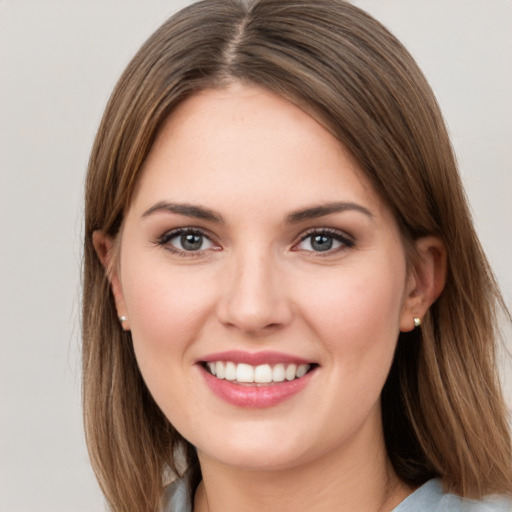 Joyful white young-adult female with long  brown hair and grey eyes