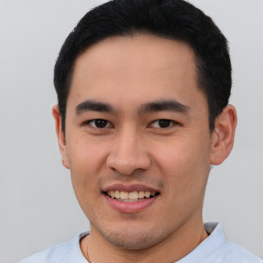 Joyful white young-adult male with short  black hair and brown eyes