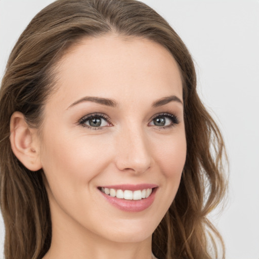 Joyful white young-adult female with long  brown hair and grey eyes