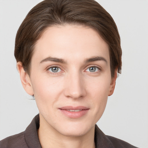 Joyful white young-adult female with short  brown hair and grey eyes