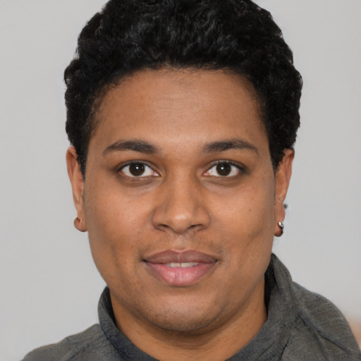 Joyful black young-adult male with short  black hair and brown eyes