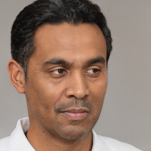 Neutral latino adult male with short  black hair and brown eyes