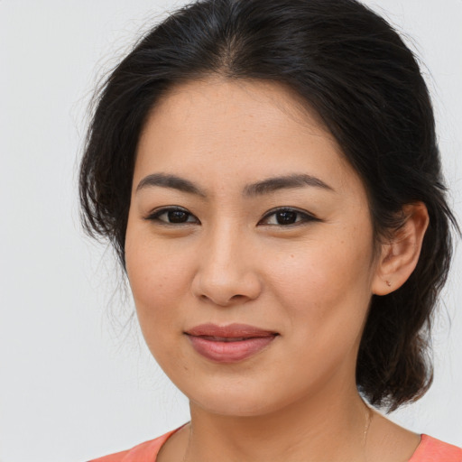 Joyful asian young-adult female with medium  brown hair and brown eyes