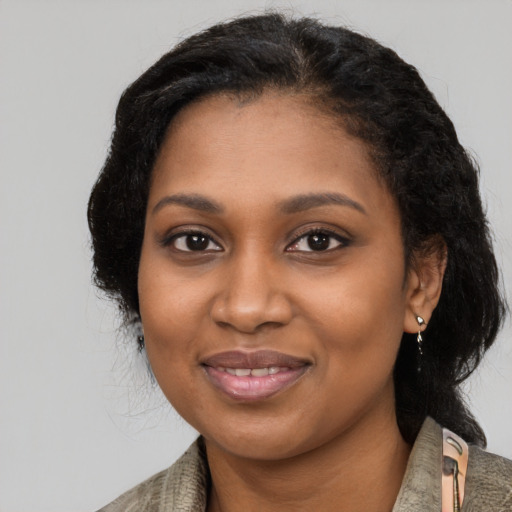 Joyful black young-adult female with medium  black hair and brown eyes