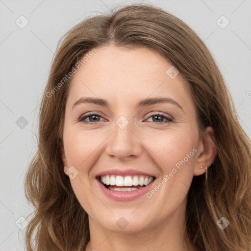 Joyful white young-adult female with long  brown hair and green eyes