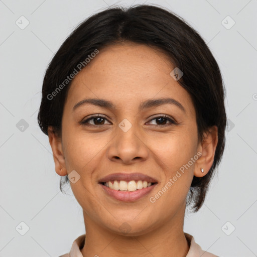 Joyful latino young-adult female with medium  brown hair and brown eyes