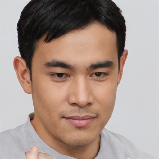 Joyful asian young-adult male with short  brown hair and brown eyes