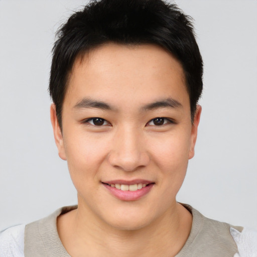 Joyful asian young-adult male with short  brown hair and brown eyes