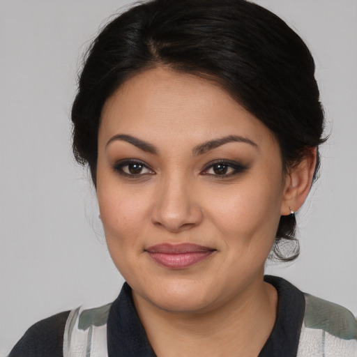 Joyful latino young-adult female with medium  brown hair and brown eyes