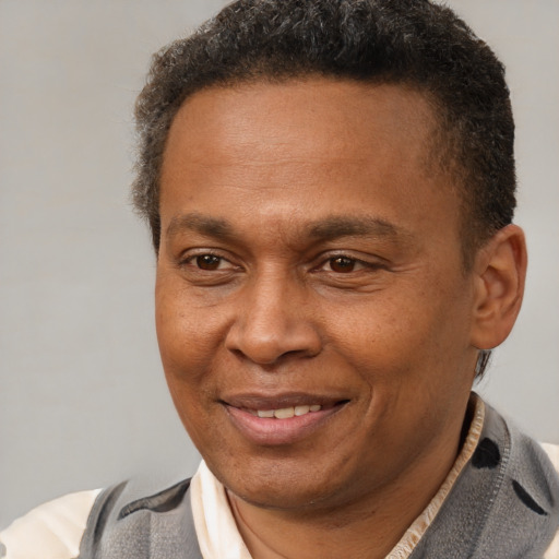 Joyful latino adult male with short  brown hair and brown eyes