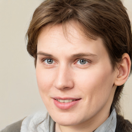 Joyful white young-adult female with medium  brown hair and grey eyes