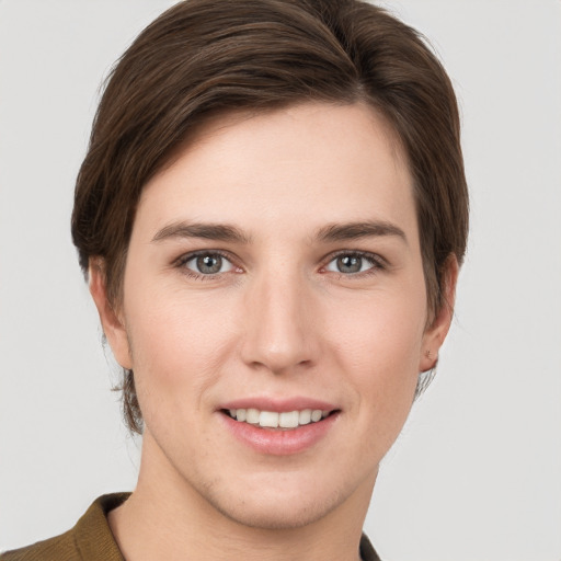 Joyful white young-adult female with short  brown hair and grey eyes