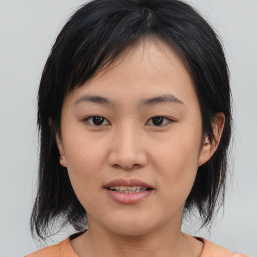 Joyful asian young-adult female with medium  black hair and brown eyes