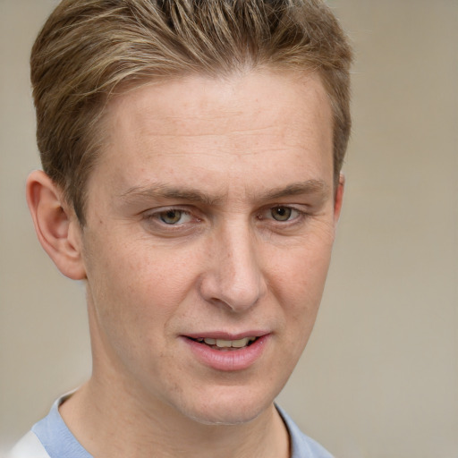 Joyful white adult male with short  brown hair and grey eyes