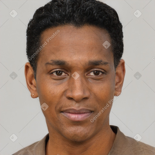 Joyful black young-adult male with short  black hair and brown eyes