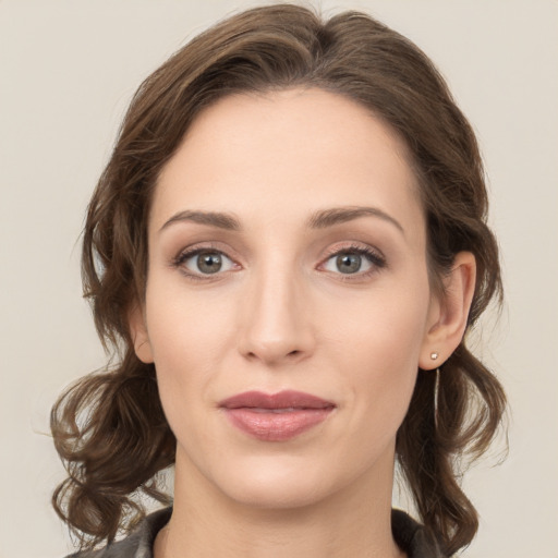 Joyful white young-adult female with medium  brown hair and green eyes