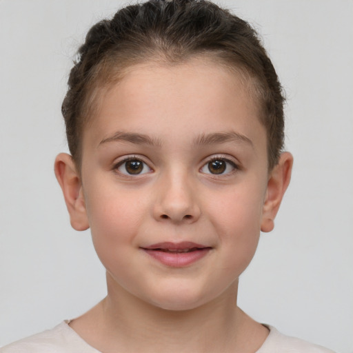 Joyful white child female with short  brown hair and brown eyes