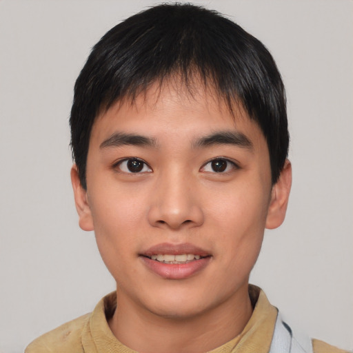 Joyful asian young-adult male with short  black hair and brown eyes