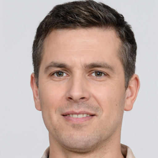 Joyful white young-adult male with short  brown hair and brown eyes