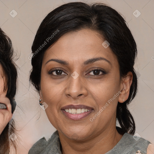 Joyful latino adult female with medium  brown hair and brown eyes