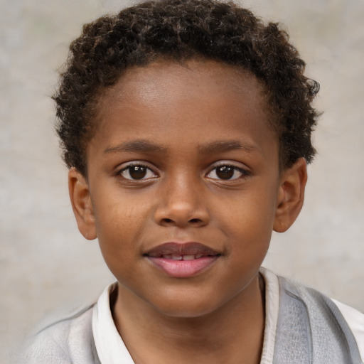 Joyful black child male with short  brown hair and brown eyes