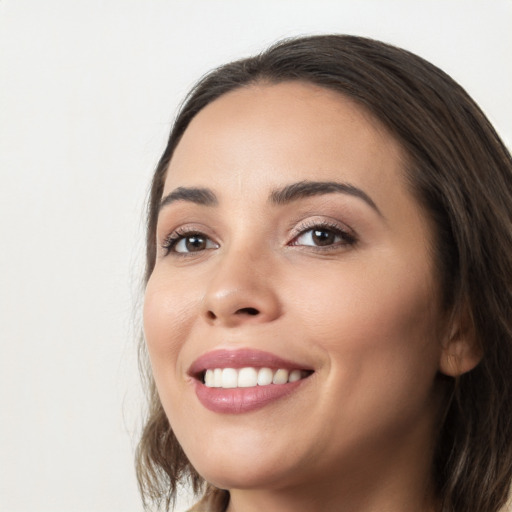 Joyful white young-adult female with long  black hair and brown eyes