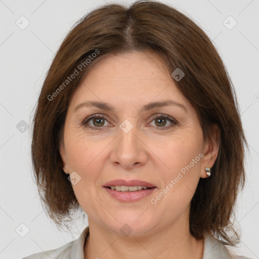 Joyful white adult female with medium  brown hair and brown eyes