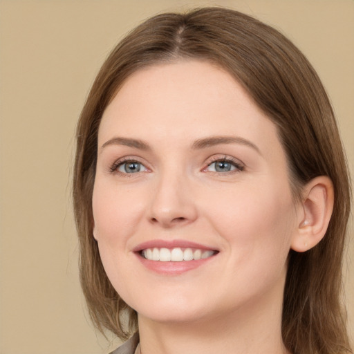 Joyful white young-adult female with long  brown hair and grey eyes