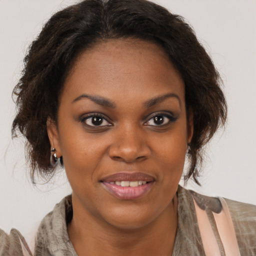 Joyful black young-adult female with medium  brown hair and brown eyes