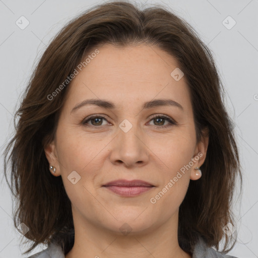 Joyful white adult female with medium  brown hair and brown eyes