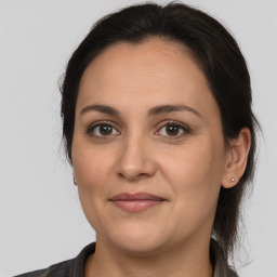 Joyful white adult female with long  brown hair and brown eyes