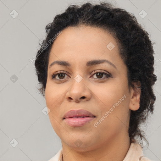 Joyful black young-adult female with long  brown hair and brown eyes